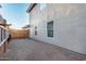 Side view of the home showing stucco siding and a side yard with decorative fence at 12229 N 121St Dr, El Mirage, AZ 85335