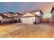 Lovely home featuring a two-car garage and desert landscaping creating inviting curb appeal at 12229 N 121St Dr, El Mirage, AZ 85335