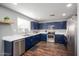 Modern kitchen with stainless steel appliances, ample cabinetry, and marble countertops at 12229 N 121St Dr, El Mirage, AZ 85335