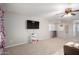 Living room with carpet, a ceiling fan, tv and some storage space at 12229 N 121St Dr, El Mirage, AZ 85335