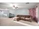 Large living room with ceiling fan, carpet, and a small treadmill at 12229 N 121St Dr, El Mirage, AZ 85335