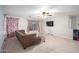 Spacious living room with plush carpet, ceiling fan, and large windows at 12229 N 121St Dr, El Mirage, AZ 85335