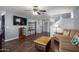 Bright living room with plush seating, TV, and easy access to other rooms at 12229 N 121St Dr, El Mirage, AZ 85335