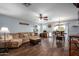 Comfortable living room with large sofa, ceiling fan, and adjoining dining area at 12229 N 121St Dr, El Mirage, AZ 85335