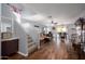 Open concept living room and dining area with modern decor and wood flooring at 12229 N 121St Dr, El Mirage, AZ 85335