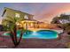 Beautiful backyard with a sparkling pool, lush greenery, and patio perfect for outdoor living and entertaining at 12229 N 121St Dr, El Mirage, AZ 85335