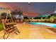 Inviting backyard pool area with sun loungers, lush landscaping, and covered patio at 12229 N 121St Dr, El Mirage, AZ 85335