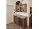 Stylish bar area with a wine cooler, granite countertop, and wooden cabinets for storing drinks and glasses at 13390 N 95Th Way, Scottsdale, AZ 85260