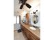 Bathroom featuring double sinks with granite countertops and custom cabinets at 13390 N 95Th Way, Scottsdale, AZ 85260