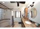 Bathroom featuring double sinks with granite countertops and custom cabinets at 13390 N 95Th Way, Scottsdale, AZ 85260