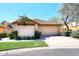 Inviting home exterior features a two-car garage, tile roof, desert landscaping, and mature shade trees at 13390 N 95Th Way, Scottsdale, AZ 85260