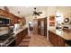Spacious kitchen with stainless steel appliances, wood cabinets, granite countertops, and tile floors at 13390 N 95Th Way, Scottsdale, AZ 85260