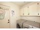 Well-organized laundry room features a washer, dryer, and plenty of cabinet space for storage at 13390 N 95Th Way, Scottsdale, AZ 85260