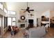 Inviting living room with a stone fireplace, ample seating, and views to the outdoor living spaces at 13390 N 95Th Way, Scottsdale, AZ 85260