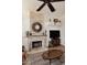 Cozy living room with a stone fireplace, built-in shelving, and neutral decor at 13390 N 95Th Way, Scottsdale, AZ 85260