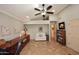 Inviting home office with neutral walls, a ceiling fan, built-in shelving and tile flooring at 13390 N 95Th Way, Scottsdale, AZ 85260