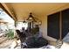 Covered patio with multiple seating areas, ceiling fans, potted plants, and doors leading inside at 13390 N 95Th Way, Scottsdale, AZ 85260