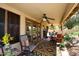 Covered patio featuring a ceiling fan, multiple seating areas, and access to the backyard at 13390 N 95Th Way, Scottsdale, AZ 85260