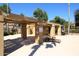 Community pool area featuring shaded lounge chairs, tables, and a pergola for a relaxing experience at 13390 N 95Th Way, Scottsdale, AZ 85260