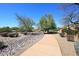 Charming street view showcasing the desert landscape with mature trees and well-maintained homes at 13390 N 95Th Way, Scottsdale, AZ 85260