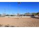 Community volleyball court with net, lights and fencing, set on a clear sunny day with bright blue sky at 13390 N 95Th Way, Scottsdale, AZ 85260