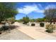 Community walking path surrounded by green desert vegetation, mature trees and bright blue sky at 13390 N 95Th Way, Scottsdale, AZ 85260