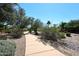 Scenic community walking path surrounded by lush greenery, trees, and serene desert landscape at 13390 N 95Th Way, Scottsdale, AZ 85260