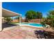 Charming backyard with a covered patio, sparkling pool, and lush landscaping, perfect for outdoor entertaining and relaxation at 13711 N 81St Ave, Peoria, AZ 85381