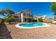 Open view of the refreshing pool, lush lawn, and mature landscaping creating a relaxing backyard retreat at 13711 N 81St Ave, Peoria, AZ 85381