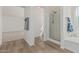 Bathroom with walk-in shower, separate soaking tub, and wood-look flooring at 13711 N 81St Ave, Peoria, AZ 85381