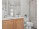A bright bathroom features a wood vanity, toilet, and shower with curtain at 13711 N 81St Ave, Peoria, AZ 85381