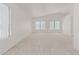 Bright bedroom with neutral carpet, vaulted ceilings, and large windows at 13711 N 81St Ave, Peoria, AZ 85381
