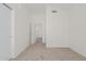 Spacious bedroom with neutral carpet, a vaulted ceiling, closet, and an open doorway to the rest of the home at 13711 N 81St Ave, Peoria, AZ 85381