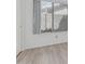 Empty bedroom featuring wood-look floors, white walls, and large windows at 13711 N 81St Ave, Peoria, AZ 85381