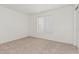 Cozy bedroom features neutral carpet, a window with blinds, and a spacious feel, perfect for relaxation at 13711 N 81St Ave, Peoria, AZ 85381