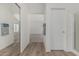 Bright hallway features wood floors, bathroom access, and an open bedroom area, enhancing flow and functionality at 13711 N 81St Ave, Peoria, AZ 85381