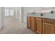 A carpeted hallway with built-in cabinetry sits between rooms in this clean, well-lit home at 13711 N 81St Ave, Peoria, AZ 85381