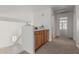 Hallway with built-in cabinet and view of the window-lined bonus room at the end at 13711 N 81St Ave, Peoria, AZ 85381