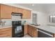 Kitchen with a sleek black oven, neutral cabinets, and ample countertop space at 13711 N 81St Ave, Peoria, AZ 85381
