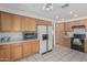 Well-lit kitchen with white appliances, light-toned cabinets, and tile flooring at 13711 N 81St Ave, Peoria, AZ 85381