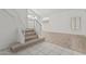 Open-concept living room featuring a staircase, modern flooring, and plenty of natural light at 13711 N 81St Ave, Peoria, AZ 85381