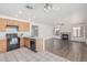 Spacious kitchen with light wood cabinets connected to the living room with a cozy fireplace at 13711 N 81St Ave, Peoria, AZ 85381