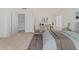 Calm bedroom with carpet, a decorative rug, lots of light, a desk and an adjoining bathroom at 13711 N 81St Ave, Peoria, AZ 85381