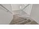 Carpeted staircase with white banister leads to the upper floor of this home at 13711 N 81St Ave, Peoria, AZ 85381