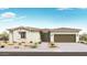 Charming single-story home featuring desert landscaping, neutral tones, a 2-car garage and covered entry at 14182 W Sand Hills Rd, Surprise, AZ 85387