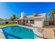 Backyard view showcasing pool, covered patio, lush lawn and white stucco home at 1449 E Kent Ave, Chandler, AZ 85225