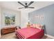 Comfortable bedroom featuring a vintage dresser, window and ceiling fan at 1449 E Kent Ave, Chandler, AZ 85225