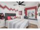 Cozy bedroom with window seat, ceiling fan, and playful wall design, creating a cheerful space at 1449 E Kent Ave, Chandler, AZ 85225