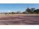 Outdoor basketball court with hoop and net ready for a game and recreational play at 1619 E Del Rio Dr, Tempe, AZ 85282