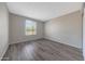 A bright bedroom features a window with blinds, gray walls, and resilient flooring at 1619 E Del Rio Dr, Tempe, AZ 85282